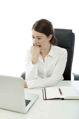 young business woman is afraid in front of laptop white backgroundの写真素材