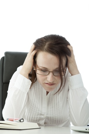 young brunette business woman with glasses is frustratedの写真素材