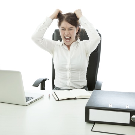 young brunette business woman is frustated hands on head and hairの写真素材