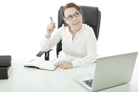 young brunette businesswoman with glasses on desk has ideaの写真素材