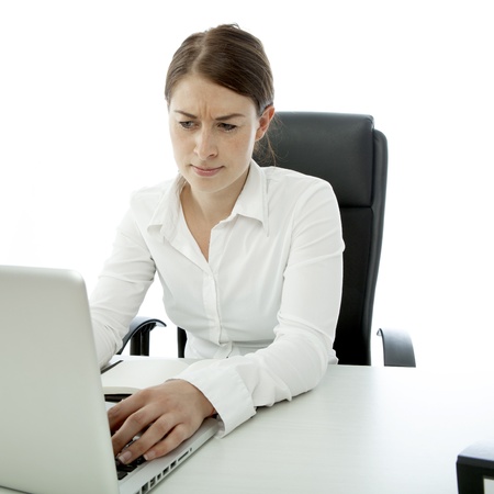 young brunette woman is uncertain on deskの写真素材