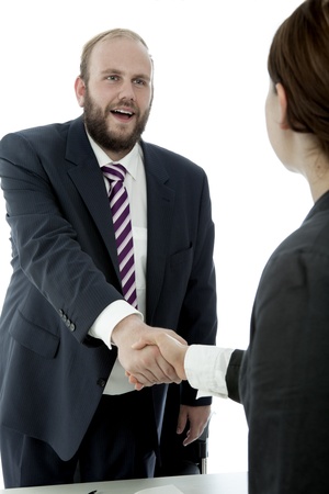beard business man brunette woman at desk の写真素材
