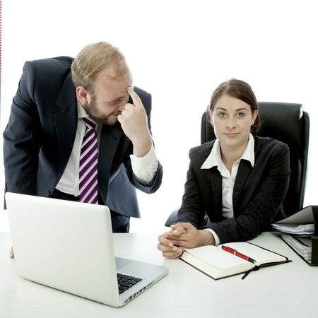 beard business man brunette woman at desk employee is stupidの写真素材