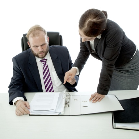 beard business man brunette woman at desk show documentsの写真素材