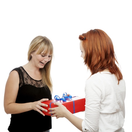 young beautiful red and blond haired girls opens gift box in front of white backgroundの写真素材