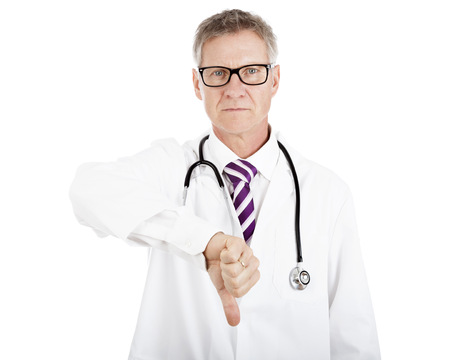 Serious Male Doctor Giving Thumbs Down Sign, Showing Failed Operation Result, Isolated on White Backgroundの写真素材