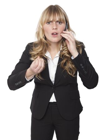 Shocked Business Woman While Calling on Phone, Looking into Camera. Isolated on Whiteの写真素材