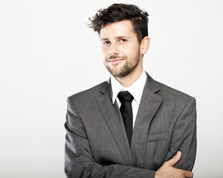 modern stylish young and trendy business man, pose in front of grey backgroundの写真素材
