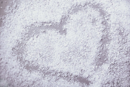 heart in snow on grey backgroundの写真素材