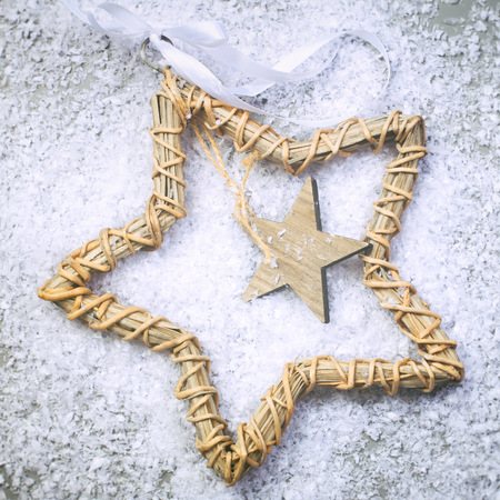 Christmas star on the snow and grey backgroundの写真素材