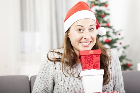 happy girl with gift boxes for somebody to giveの写真素材