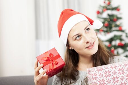 young happy girl is getting surprised of christmas giftの写真素材