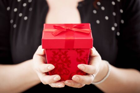 young red haired happy girl close up of a christmas presentの写真素材