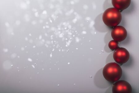 decorative row of christmas balls with snowflakes on grey background, cool filter lookの写真素材