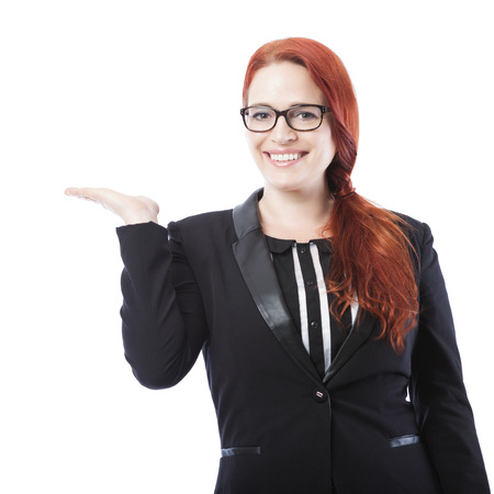young beautiful business woman present something beside her, isolated on white backgroundの写真素材