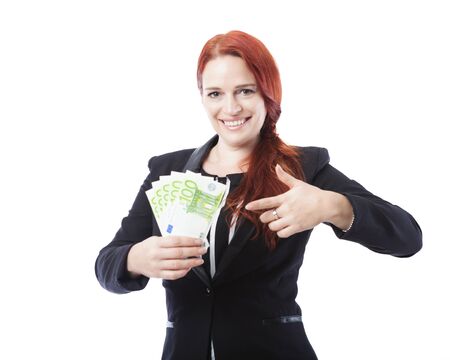 young beautiful business woman point to a lot of euro bank notes, isolated on white backgroundの写真素材