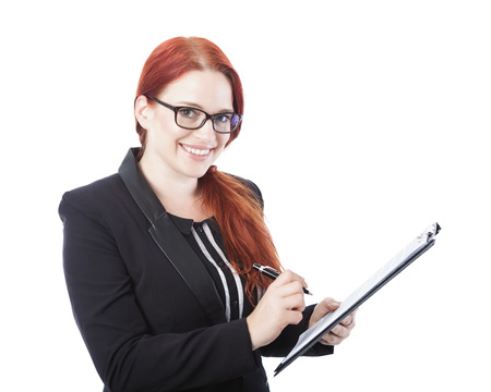 young beautiful business woman with glasses sign documents in her hand, isolated on white backgroundの写真素材
