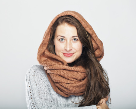 young happy cute winter woman, isolated on grey backgroundの写真素材