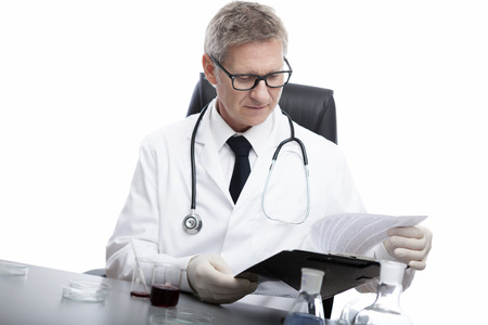 scientist or doctor is looking and analyse clipboard solution, in lab or hospitalの写真素材