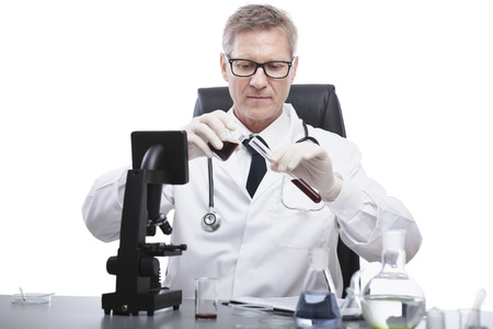 scientist or doctor is looking and analyse blood test tube, in lab or hospitalの写真素材