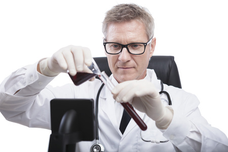 scientist or doctor is looking and analyse blood test tube, in lab or hospitalの写真素材
