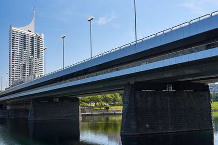the danube river on a beautiful sunny day and the business center of the city and the skyscrapers of vienna in the backgroundの写真素材