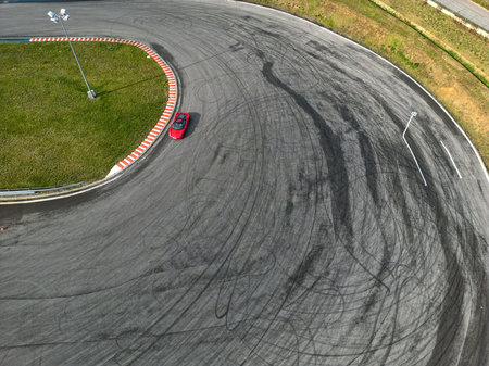 car racing track and racing cars as seen from above from a drone. Fast, luxury cars.
