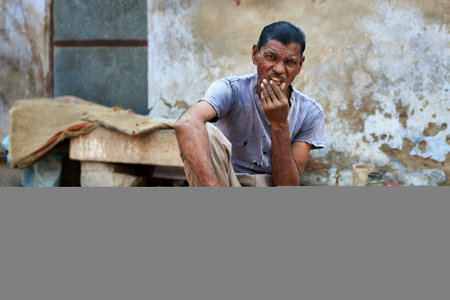 Unidentified Nepali man smoking a cigarette in Kathmandu, Nepalのeditorial素材