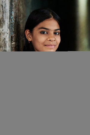 Portrait of a young woman smiling and looking at the camera.