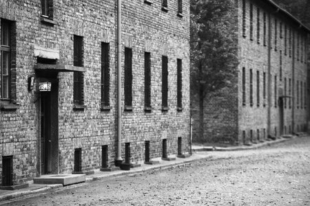 Black and white photo of an old brick building in the street.のeditorial素材
