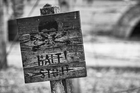 Old wooden sign in a rural area, black and white photo.のeditorial素材