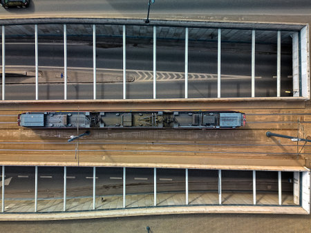 Aerial View of a Single Tram Traveling on a Bridge Over a Road in ÅÃ³dÅº, Poland, Captured...