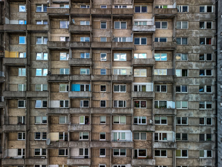 Close-up of a Soviet-era apartment block facade in ÅÃ³dÅº, Poland, showing a grid of...