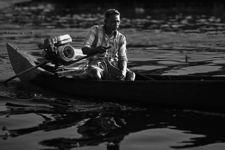 A man in a boat on the river. Black and white photo.のeditorial素材