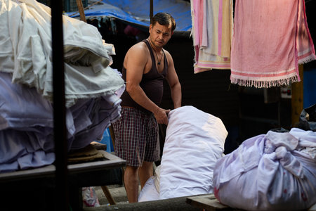 Unidentified Thai woman selling clothes in the morning market.のeditorial素材