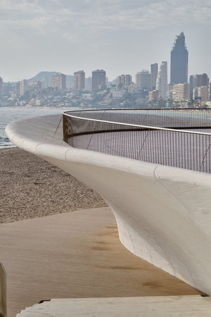 Modern coastal promenade railing Benidorm city skyline background contemporary architecture Spain waterfront designのeditorial素材