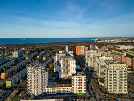 Wide aerial panorama of Przymorze district showing dense residential developments and Baltic horizon, vibrant light, travel guide useの写真素材