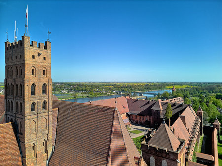 Medieval Malbork Teutonic castle aerial view defensive tower brick architecture landscape photography drone perspective HDR processing clear blue skyのeditorial素材
