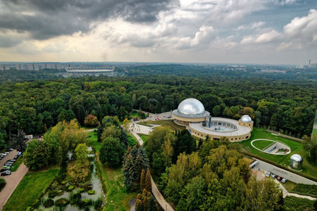 Aerial view of abandoned swimming pools with weathered blue paint surrounded by colorful autumn foliage in Silesian Park Katowice Chorzow Poland urban decay derelict structureの写真素材
