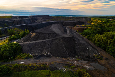 Coal mining waste dump aerial sunset view Rybnik Poland industrial landscape black heap forest...
