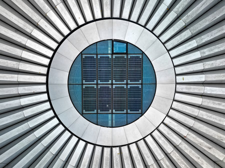 Drone view of the architectural details of the round roof structure with integrated solar panels in Warsaw's city center, Poland. The image captures the symmetry and modern design of the rooftop.の写真素材
