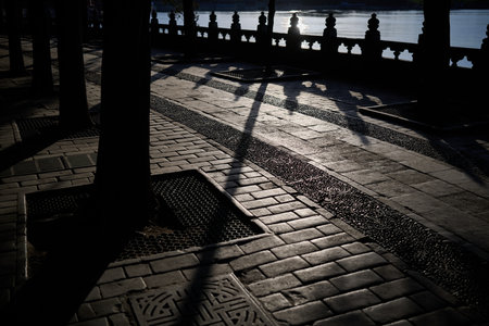 Stone archway gate entrance with red pavilion beyond, architectural framing, horizontal compositionの写真素材