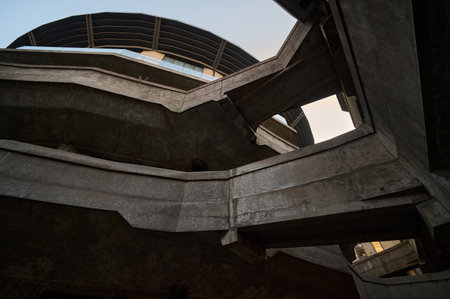 Fashion installation with metallic spiked dome headpiece and dramatic stage spotlight lightingのeditorial素材