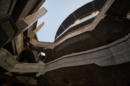 Minimal underground corridor with warm accent lighting dramatic perspective and structural elementsのeditorial素材