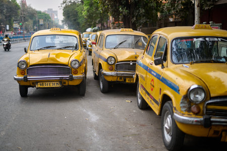 Yellow Ambassador taxis parked on a street in Kolkataのeditorial素材