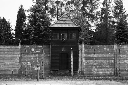 Watchtower and electrified barbed wire fence at Auschwitz camp