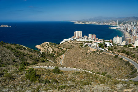 High angle view of winding roads in the Sierra Helada mountains overlooking Benidorm Island and the...