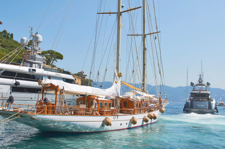 Traditional wooden schooner sailboat anchored in the harbor of Portofino, Genoa, Liguria, Italy,...