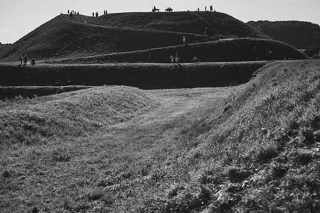 People walking along the grassy paths and earthwork fortifications of Garrison Hill (Gora Gradowa)...