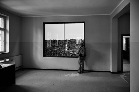 Visitor looking at shoe exhibit in Auschwitz museum